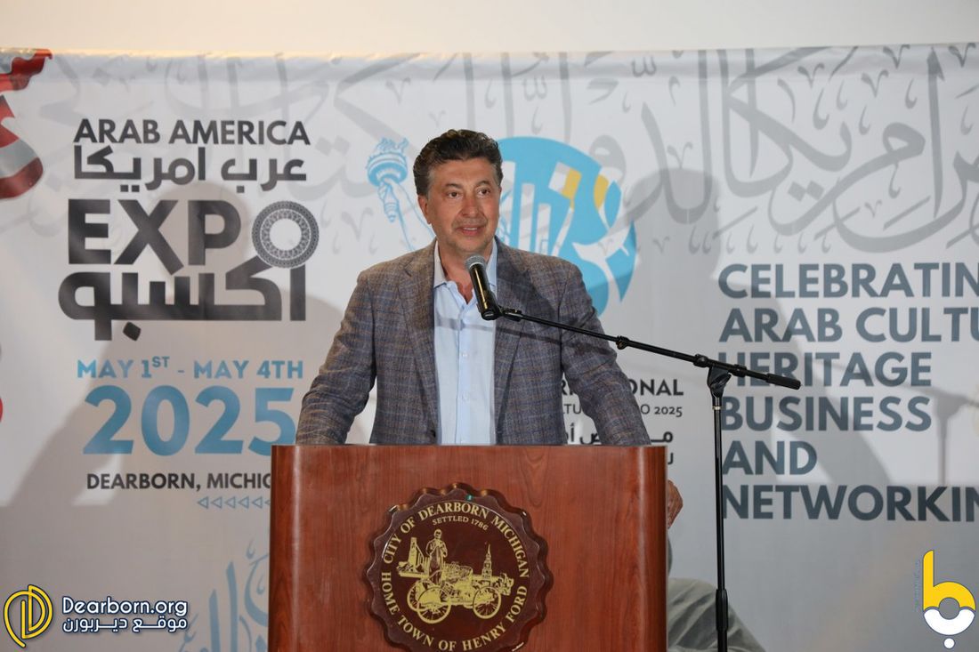 Organizer speaking at the podium during the Arab-America Expo 2025 in Dearborn